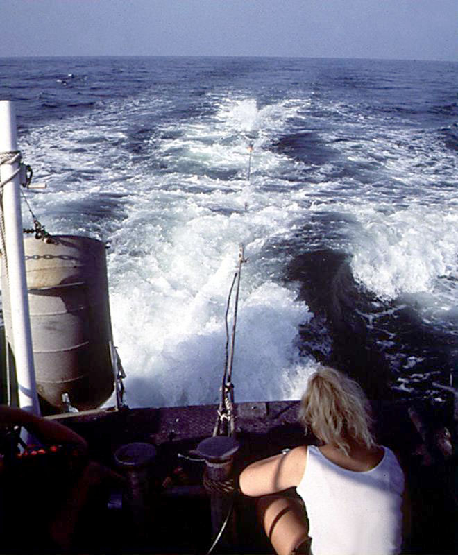 photo of a floating magnetometer being pulled behind a boat