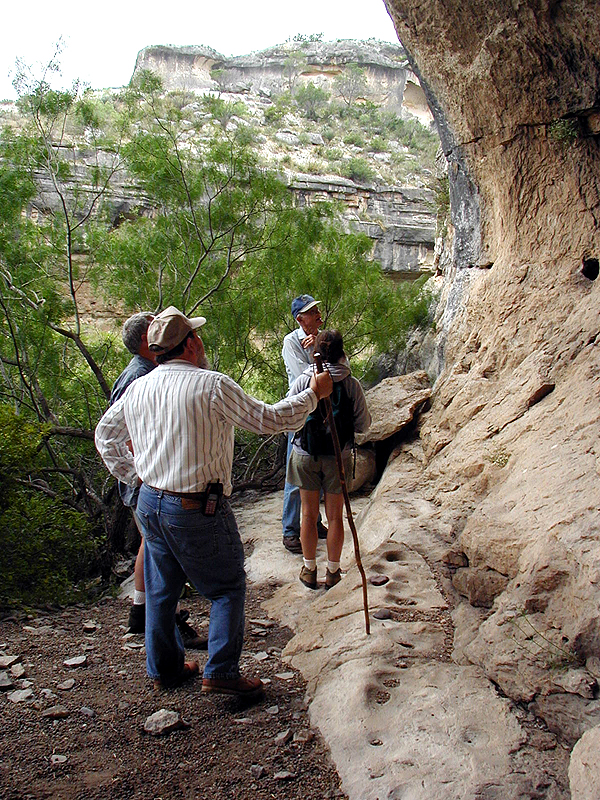 Here the group looks for the small dark green "VV numbers" - Val Verde County site numbers -- which archeologists painted in each cave and rockshelter they recorded.