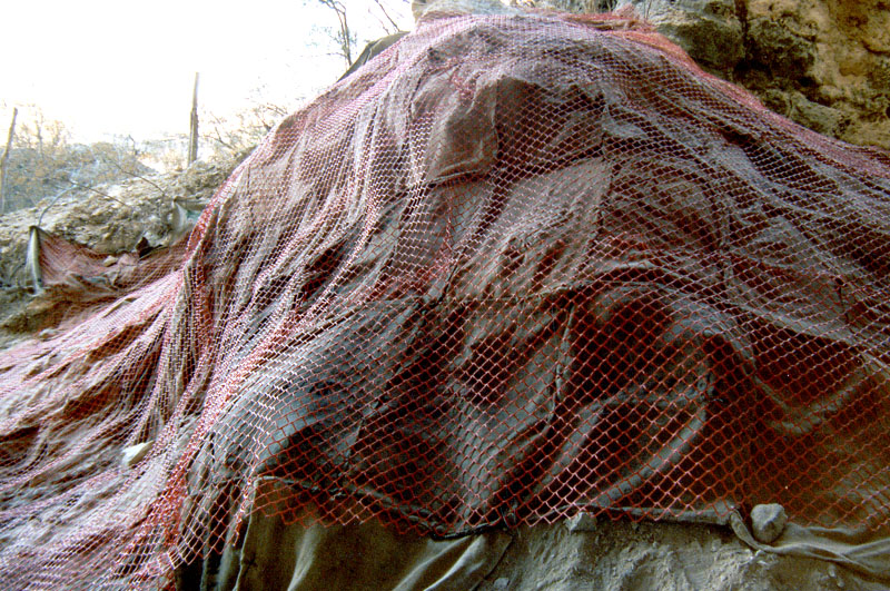 The talus cone at Bonfire wrapped in stitched-together burlap bags and safety netting to protect the deposits from erosion.