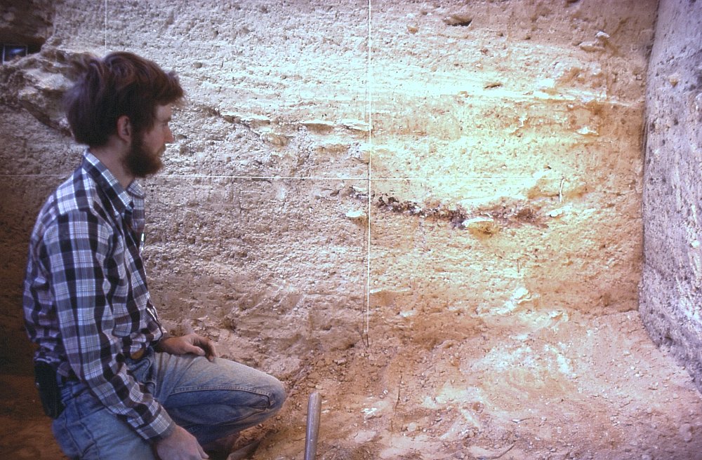 Lee Bement examines Intermediate Horizon hearth exposed in profile at Bonfire, 1983. Photo by Jack Skiles.