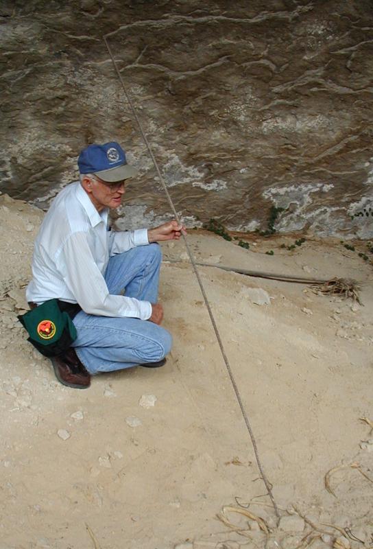 Jack Skiles holds iron rebar he drove into the bottom of the deepest excavation pit in search of bedrock. Photo by Steve Black, 2001.