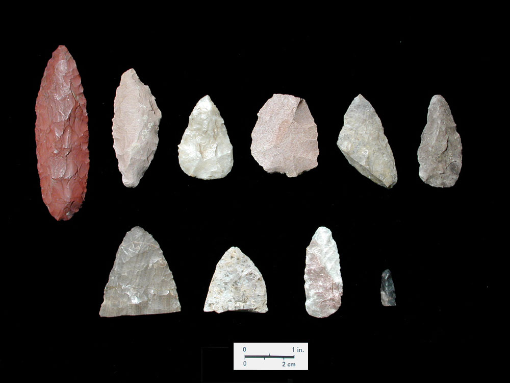 Chipped stone tools. The three specimens in the center of the top row are dart points, the third one made of quartz crystal. The other objects are tools chiefly used for hide scraping, cutting, and other butchering tasks.
