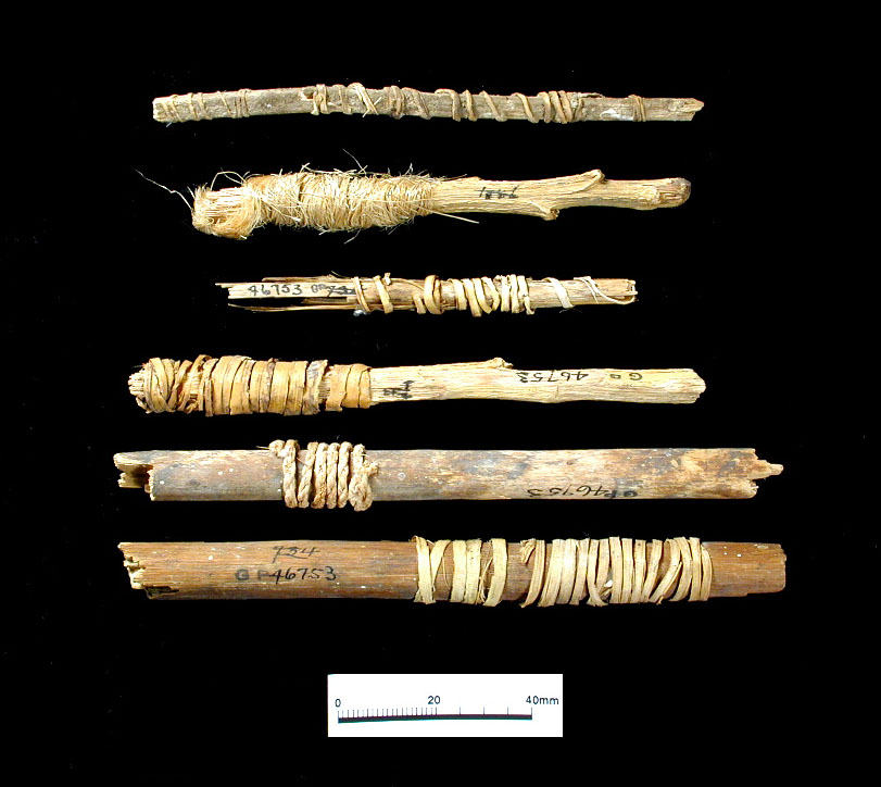 Closeup of wrapped yucca stalks and spear shafts. The bottom two specimens are wrapped in cordage , which may have been used to attach fiber bolls, or pouches, containing tobacco. A complete spear with such an attachment, found in Ceremonial Cave, is now in the National Museum of Natural History, Smithsonian Institution.