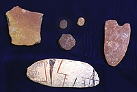 Worked sherds. Center, gaming or counting pieces; left, paint palette; bottom, pottery smoother made on sherd of Casas Grandes tradeware; right, pottery jar rim template or shaper.