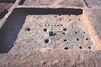 Room 1 contained a variety of floor features including a hearth near the center of the south wall, two primary roof supports on an east-west axis, and rows of smaller postholes that probably supported a raised platform. This is an average-sized habitation room of about 12 square meters that probably also served a variety of functions.