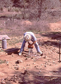 Dr. Wulf Gose drilling core samples from stones in hearth for archeomagnetic analysis. Photo by Chuck Hixson.