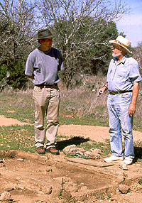 Chuck Hixson (left) and Wulf Gose confer over archeomagnetic sampling procedures for hearth stones form the site.