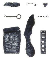Necessities and pleasures, these items representing daily life range from a shoe-button hook for a high top boot (middle row, left) to a Prince Albert tobacco can, to a harmonica reed (bottom row, right). They hold temporal information as well. The leather sole, center, was made to fit the left foot. Prior to the Civil War, shoes were universal in cut and could be worn on either foot. The Prince Albert tobacco can holds a more obvious clue, marked as "Process Patented Since 1907." Photo by Elizabeth Andrews.