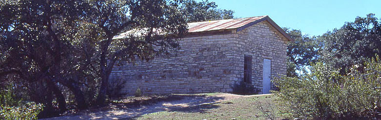 Stone building known locally as "Holman's Store" may have served as a focal point for the small Barton Creek community near the turn of the twentieth century. The well-constructed shotgun style structure had a door and a window at each gabled end and was partitioned across the center of the interior. Photo by Tom Hester.