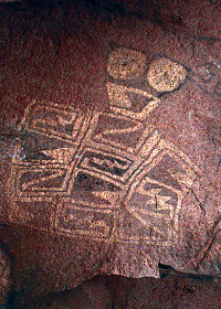 photo of a pictograph of “goggle-eyed” figure with geometric-design body