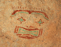 photo of a star-eyed face utilizing blue/green pigment,