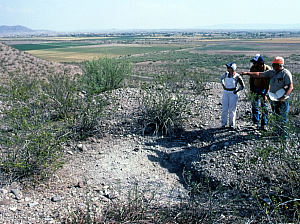 photo of J. Charles Kelley pointing to an area he excavated at the Loma Alta site in 1939