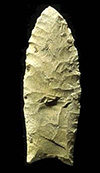 photograph of a spear point on a black background