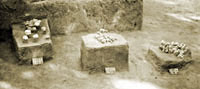 photograph of excavated features; clusters of stones on pedastalls/pillars of dirt