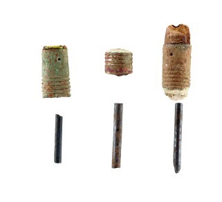 photograph of pencil lead and eraser stubs on white background