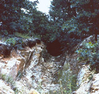 Photograph of a rocky channel forming low bluffs.