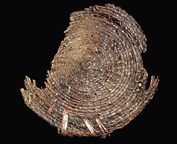 The bottom portion of a large basket that was tightly woven and sealed with pitch or resin to make it water-tight. From the ANRA-NPS collections at TARL.
