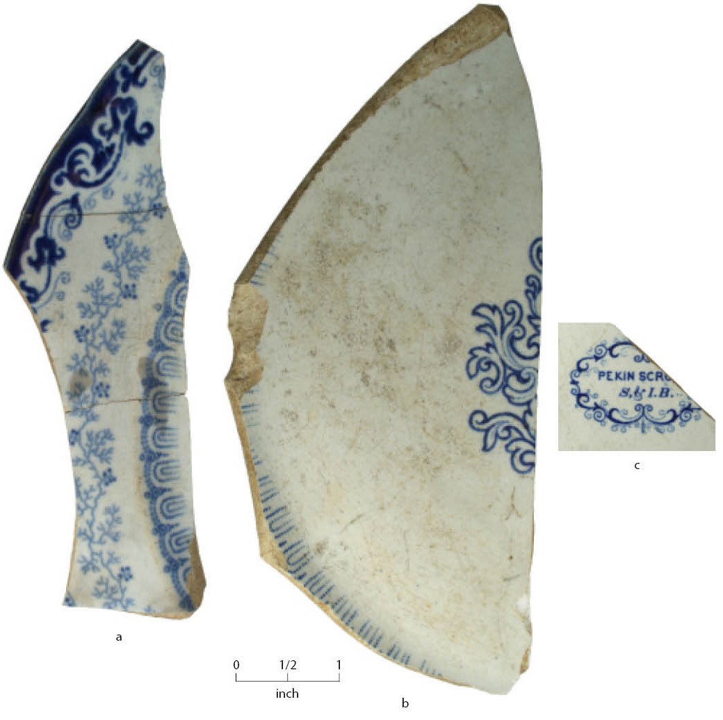 Colorfully decorated pottery sherds on a white background with a scale bar.