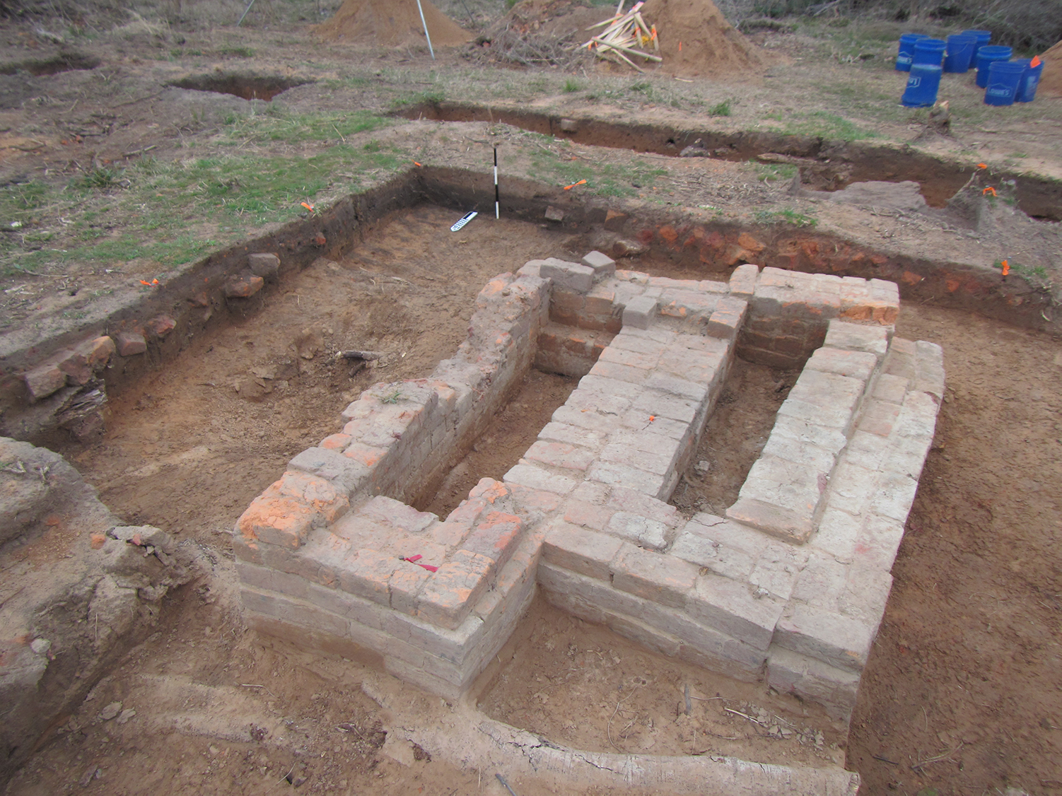 photo of excavation area mostly covered by patterns of bricks representing a chimney base