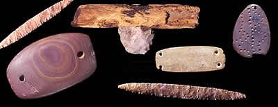 photographs of stone tools on a black background