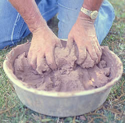 Photo of clay being mixed and kneaded