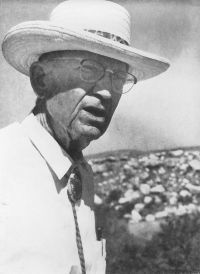 B&W photo of old man in white straw hat and bolo tie.