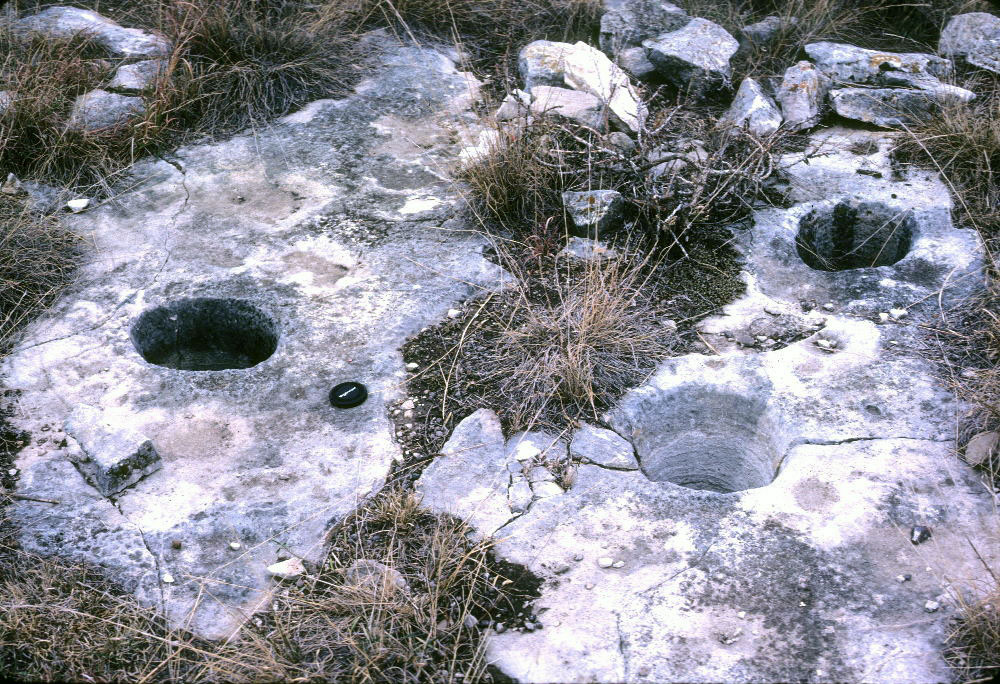 photo of bedrock mortar holes on ledge near cairn sites, Irion Count