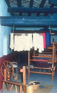 photo of a spinning wheel and loom