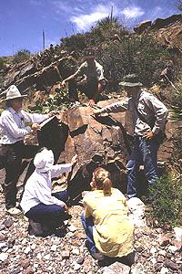 Mike Bilbo and ranger from Hueco Tanks discuss Pueblo period petroglyphs in Fusselman Canyon.