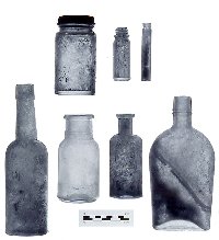Examples of the many bottles and jars found; some provided important clues in dating the site. The bottle on bottom left probably held a toiletry item and was made before 1900, whereas the "shoo-fly" picnic flask (bottom right) was fully machine made after 1920 and likely held whiskey. The bottle on the far right (bottom row) carries more information, an embossed label marked " Dr. J.J. Tobin, Druggist, Austin, Texas." Early city directories tell us Dr. Tobin operated in Austin from 1872 to 1896.