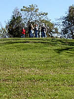 visitors at the top of a mound at the Crenshaw site in Arkansas