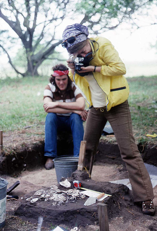 Image of Barbara Atkins photographing an oyster shell concentration.