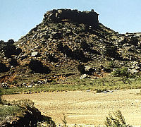 Photo of small, rocky, flat-topped hill.